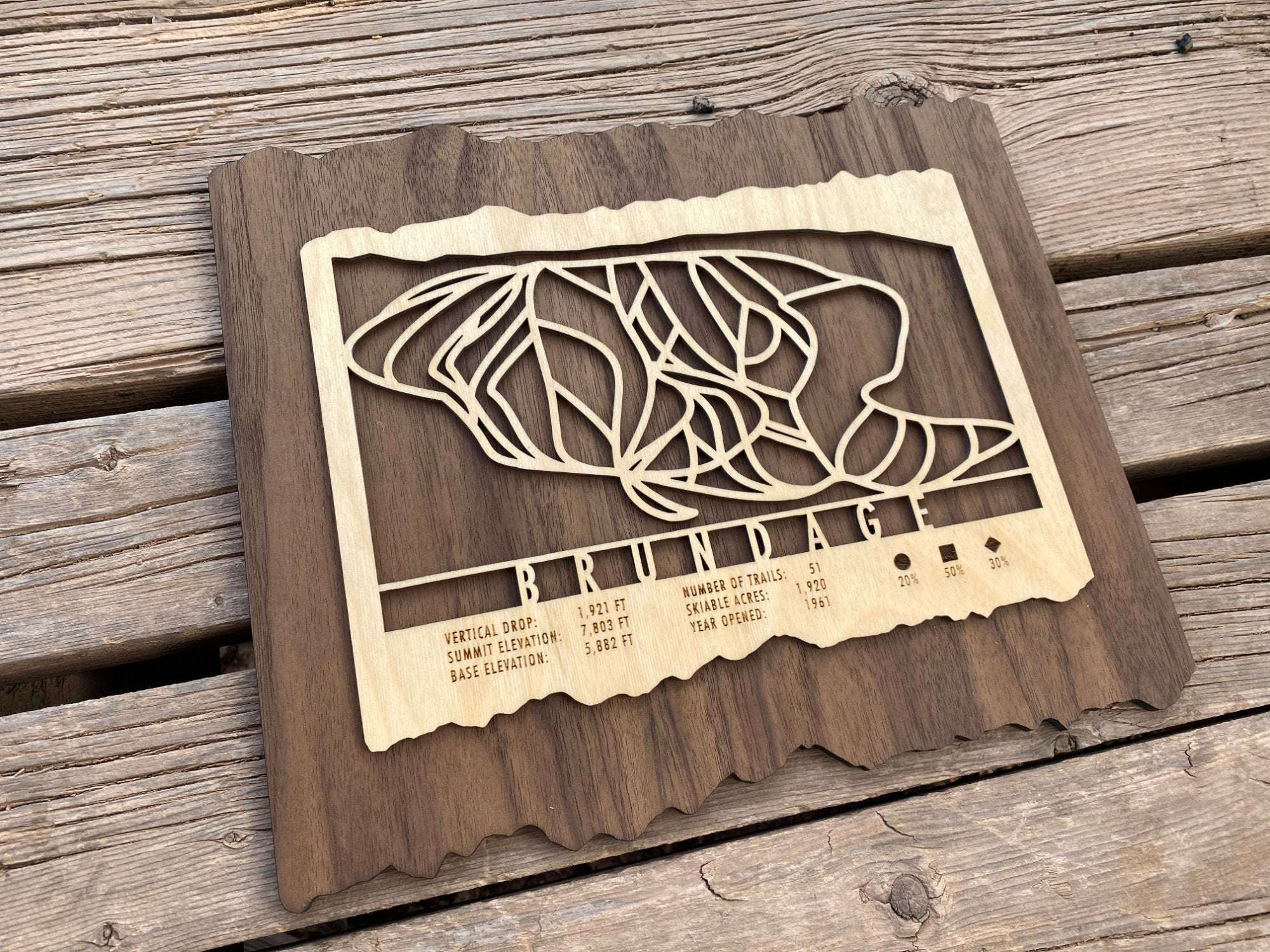 Angled view of Brundage Ski Trail Map - Wood Ski Decor showing detailed laser-cut trails and engraved mountain stats.