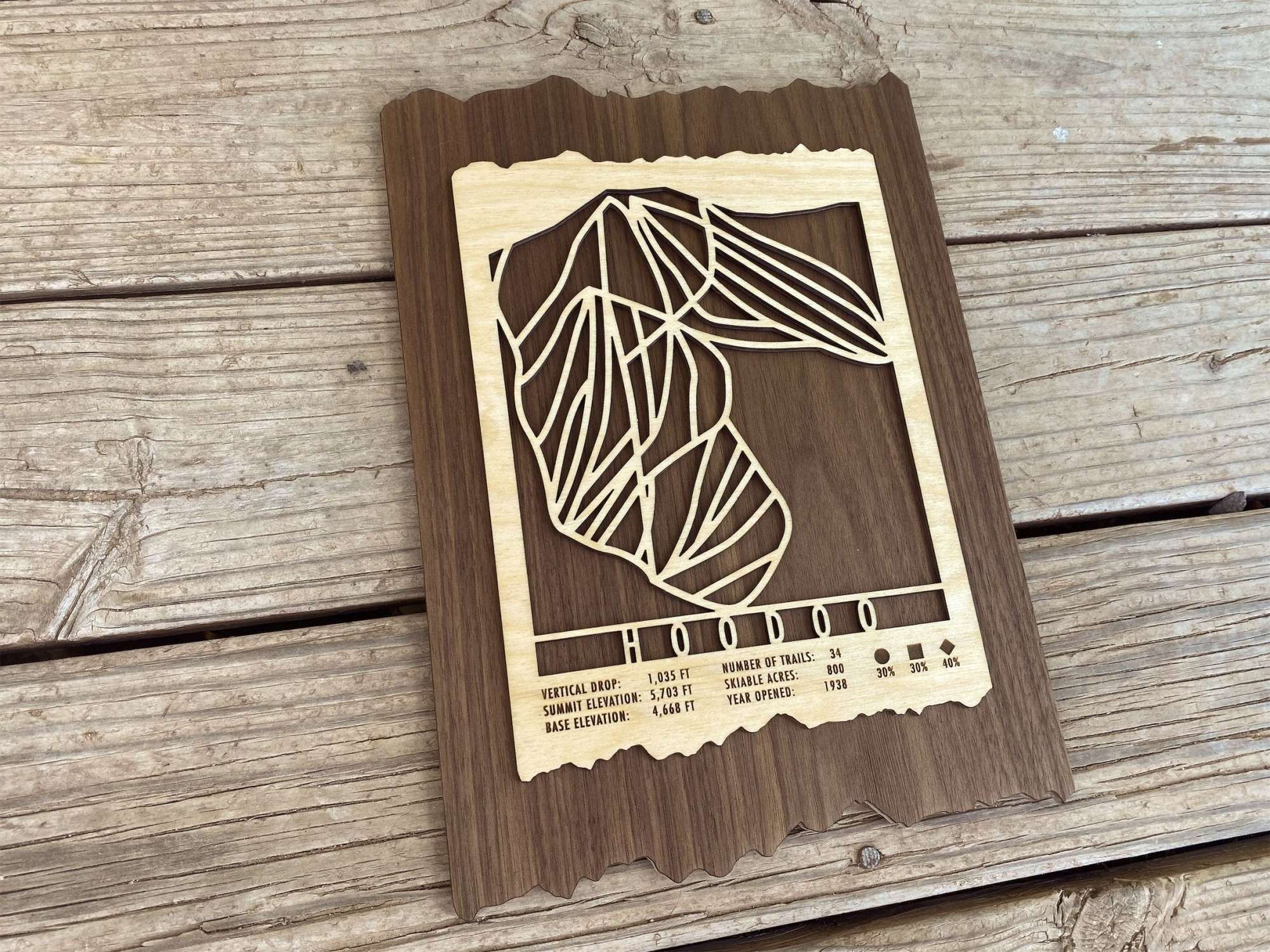 Angled view of Hoodoo Ski Trail Map - Wall Decor - showing detailed wood craftsmanship and engraved ski trail layout for Oregon ski resort.
