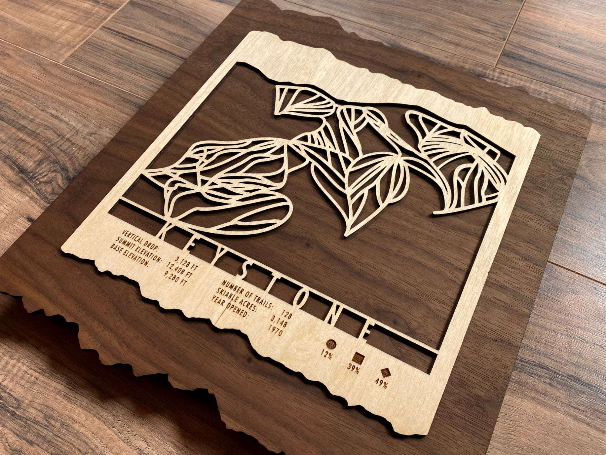 Angled view of Keystone Ski Trail Map showing intricate wooden trail design and engraved ski stats, perfect for Colorado ski lovers.
