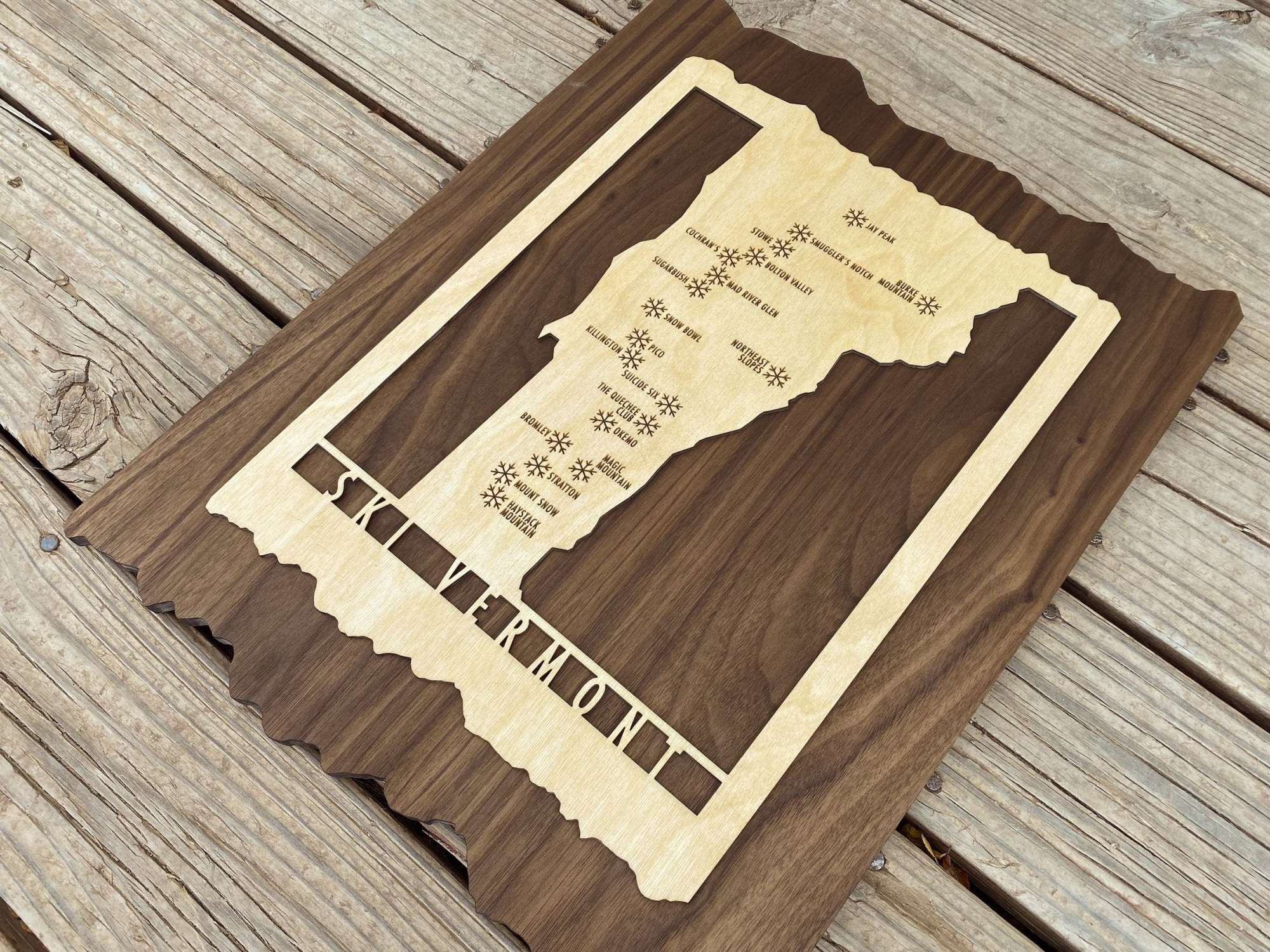 Angled view of Ski Vermont wood ski resort map decor, handcrafted with engraved mountain names and rustic finish.