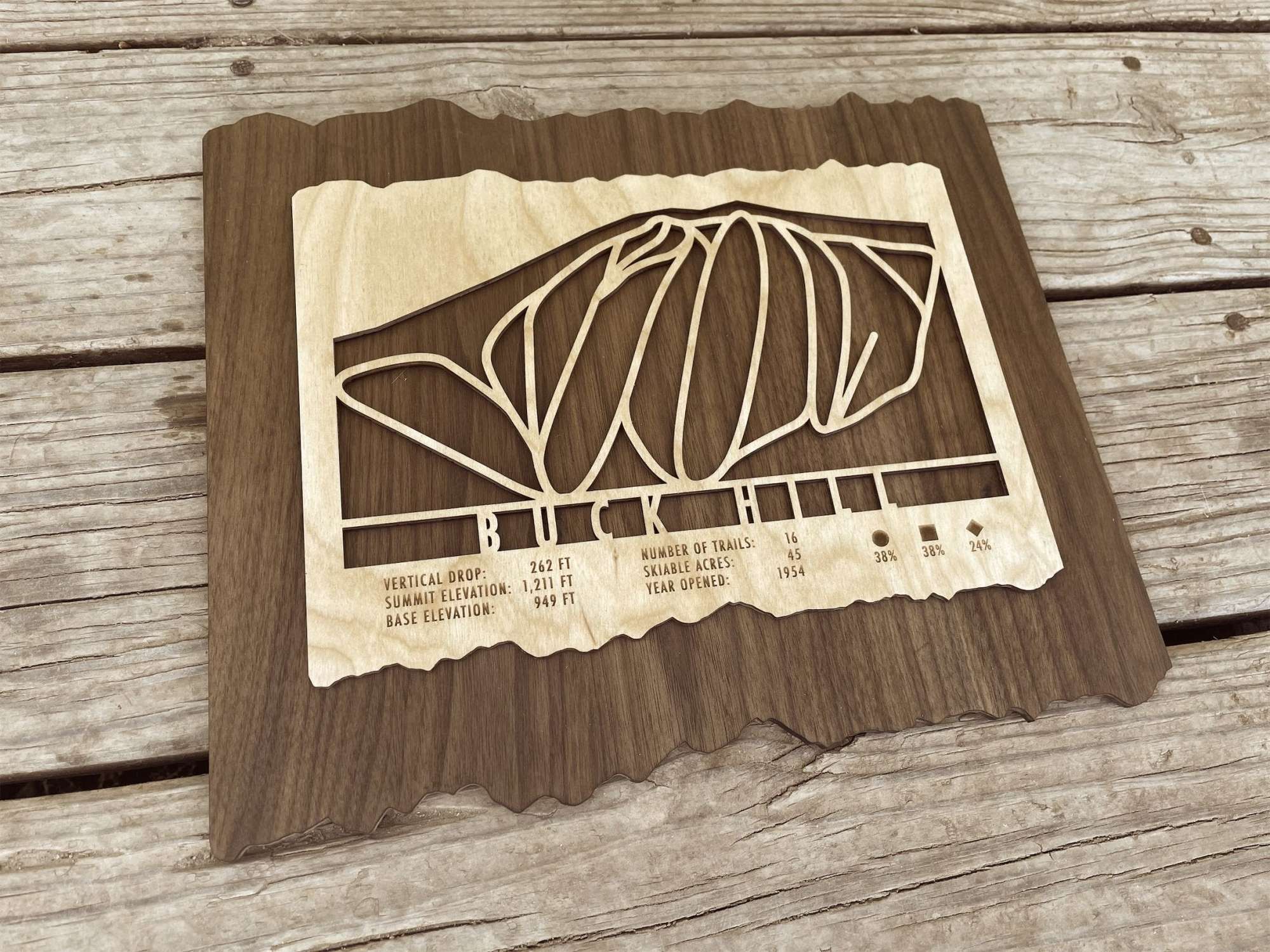 Angled view of Buck Hill Ski Trail Map - Wall Decor - MountainCut showing detailed wood craftsmanship and engraved trail layout for Minnesota ski resort.