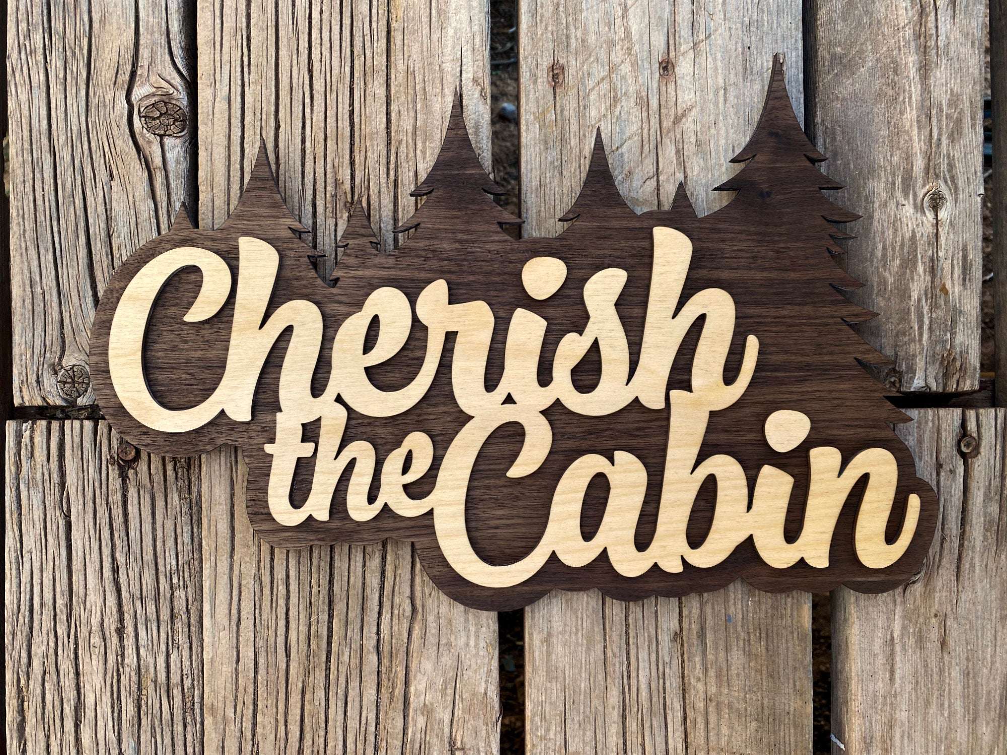 Cherish the Cabin wood sign, featuring forest silhouette and cozy cabin aesthetic for cabin-lovers and Seinfeld-lovers..