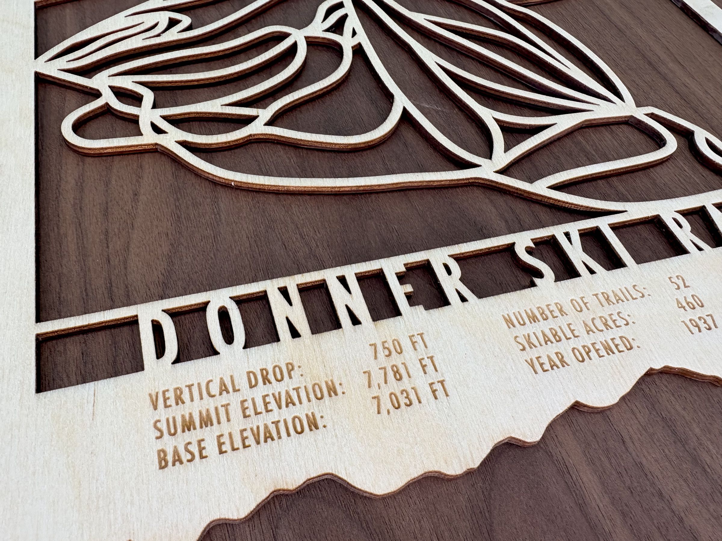Detailed view of Donner Ski Ranch wood ski map with engraved elevation, trail count, and skiable acres, ideal for ski lodge artwork.