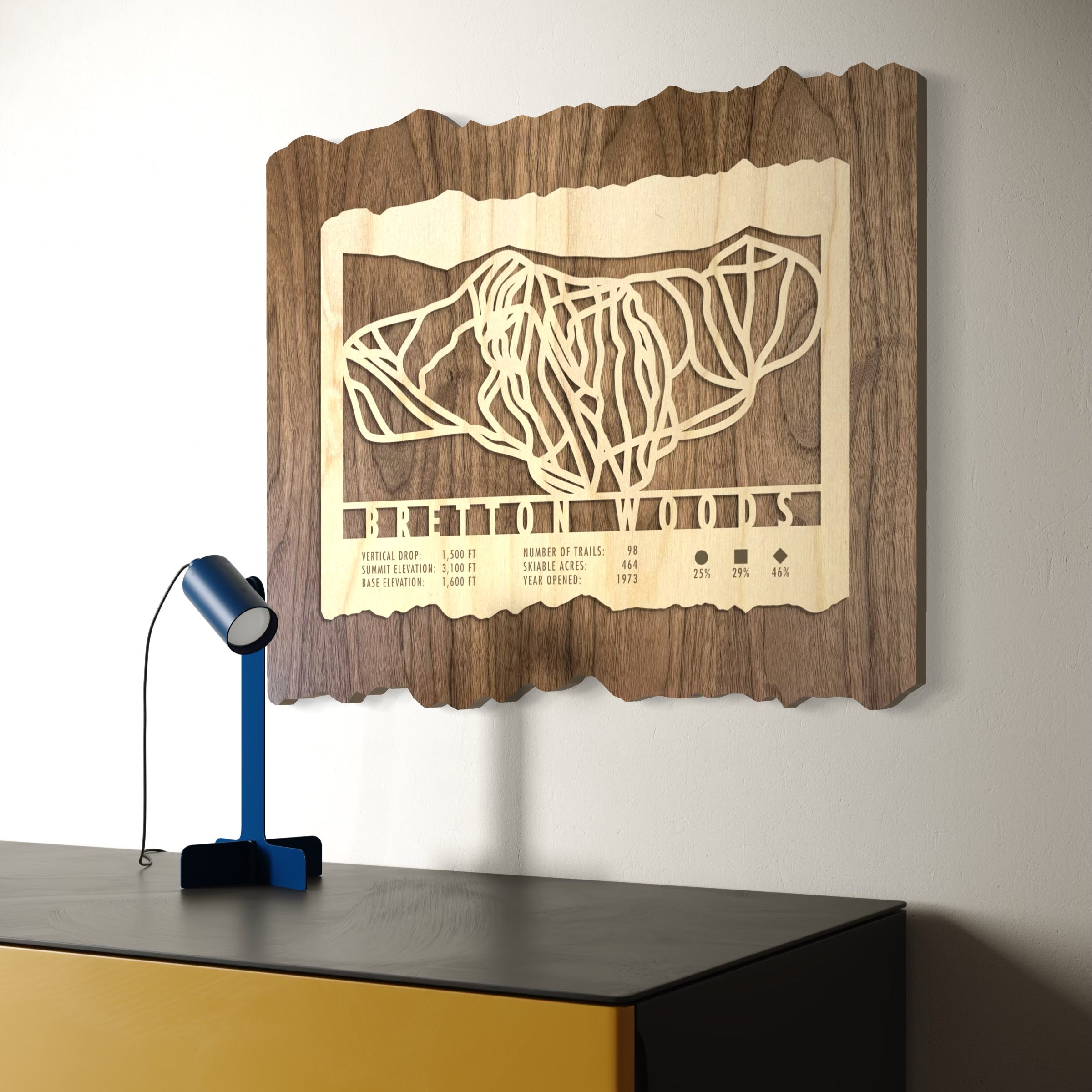 Wood ski trail map of Bretton Woods New Hampshire. Hanging on a white wall above furniture.