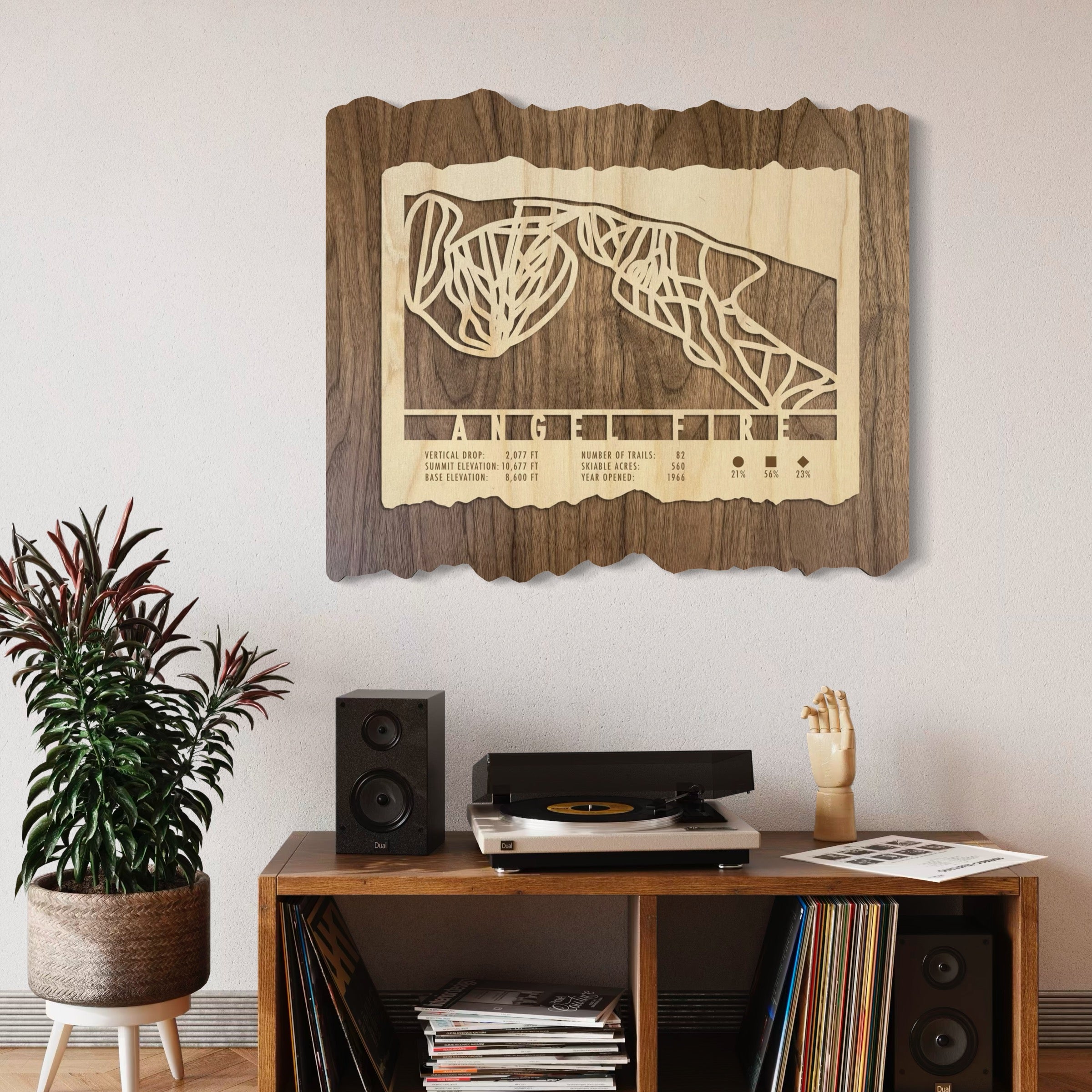 Angel Fire ski trail map hanging on wall above stereo