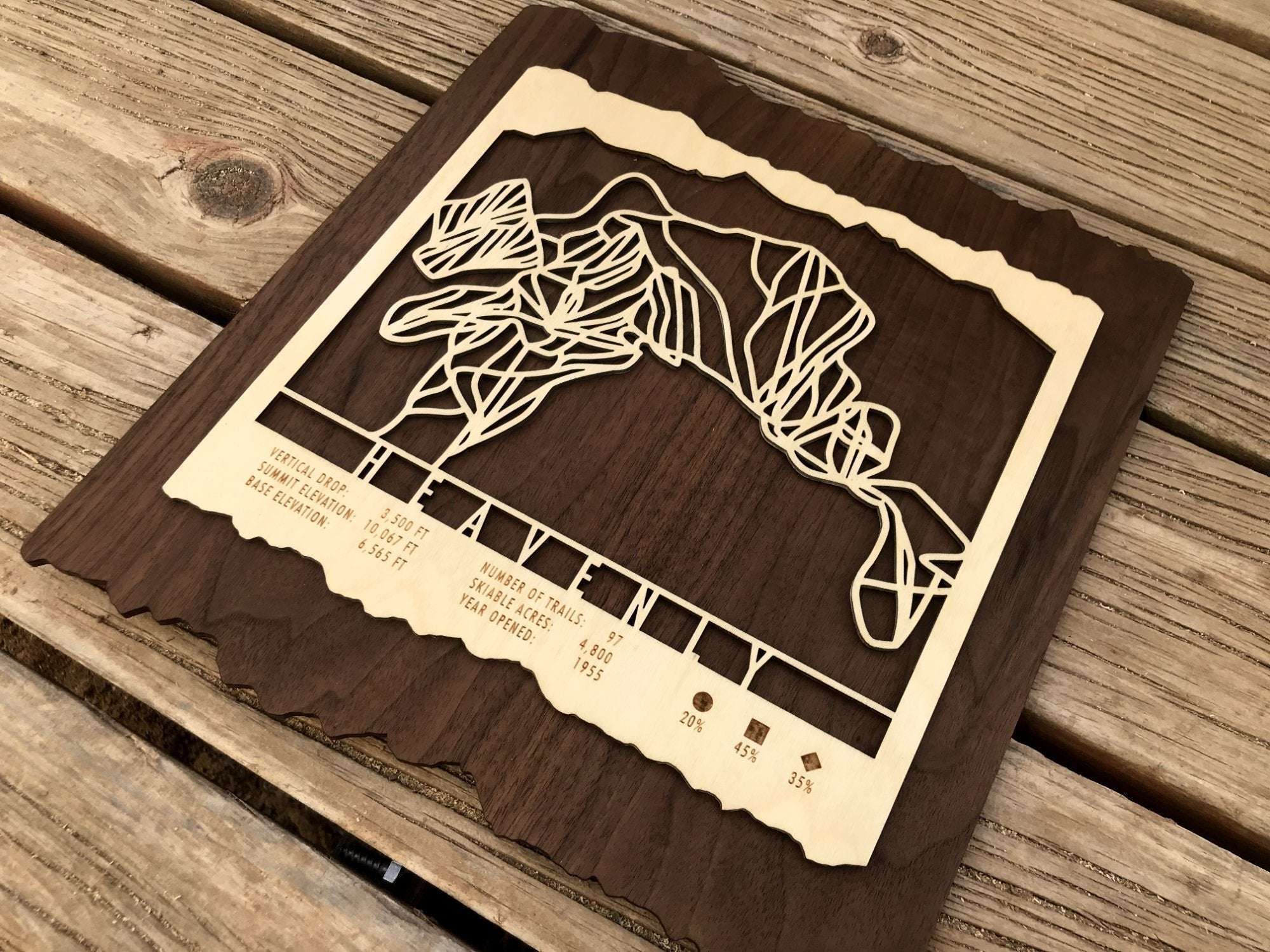 Close-up of the Heavenly Ski Trail Map highlighting the precision-cut ski trails and engraved mountain data on natural wood.