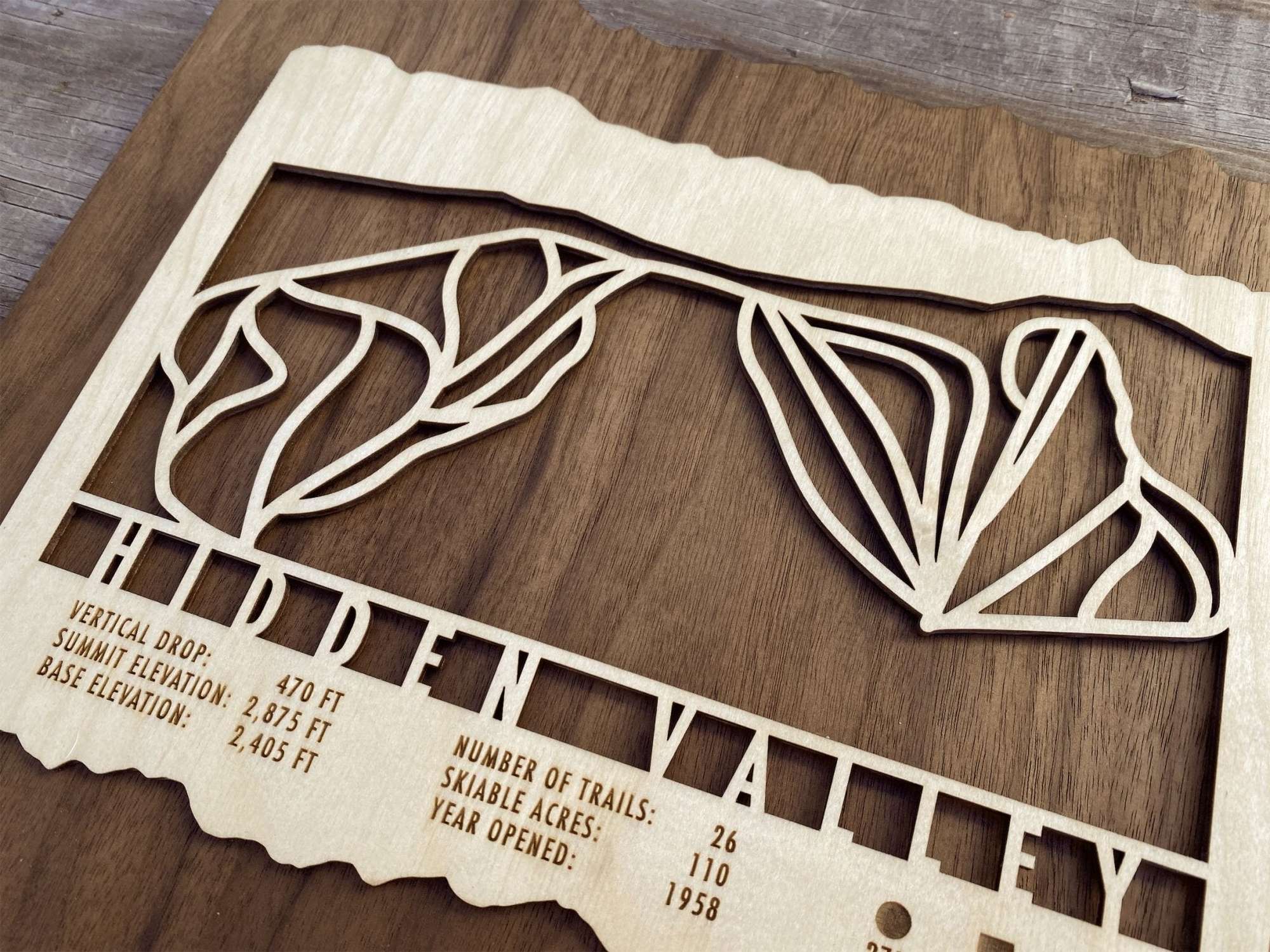 Close-up of Hidden Valley Pennsylvania Ski Trail Map wood artwork, highlighting detailed trail engravings and elevation stats.