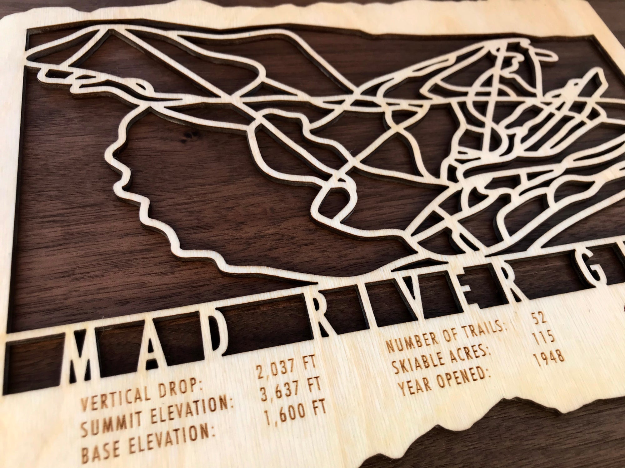 Detailed view of Mad River Glen wood ski map with engraved elevation, trail count, and skiable acres, a unique gift for skiers.
