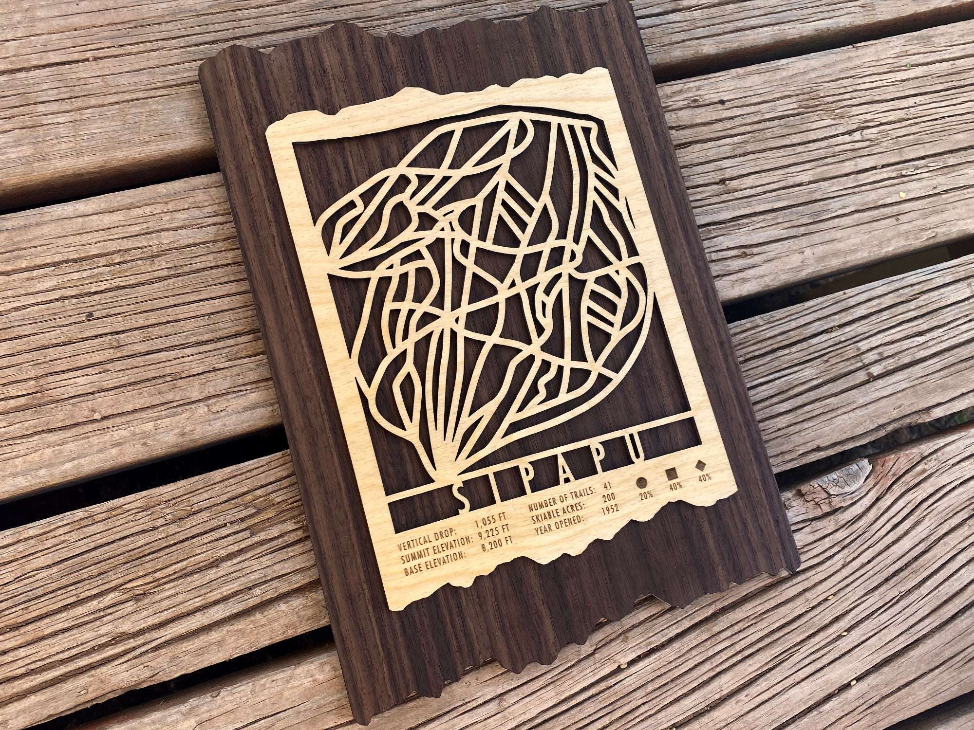 Angled view of Sipapu Ski Trail Map showcasing the engraved mountain stats of this New Mexico ski area.