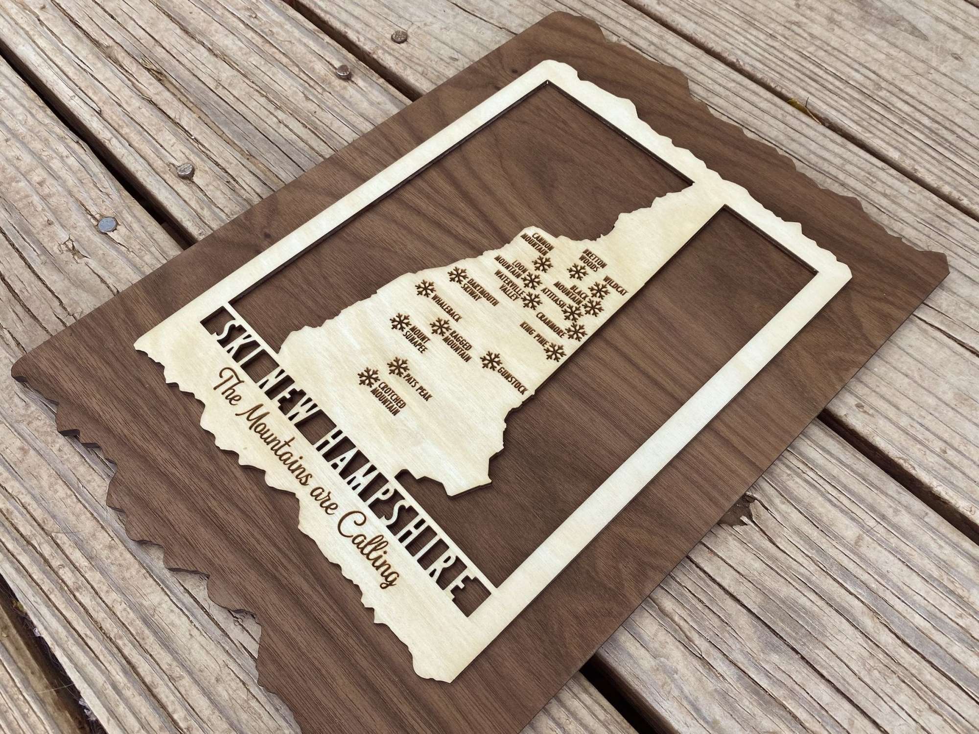 Perspective view of Ski New Hampshire Map - Wood Ski Decor - Mountaincut with detailed engraving and rustic wood frame for home or cabin decor.