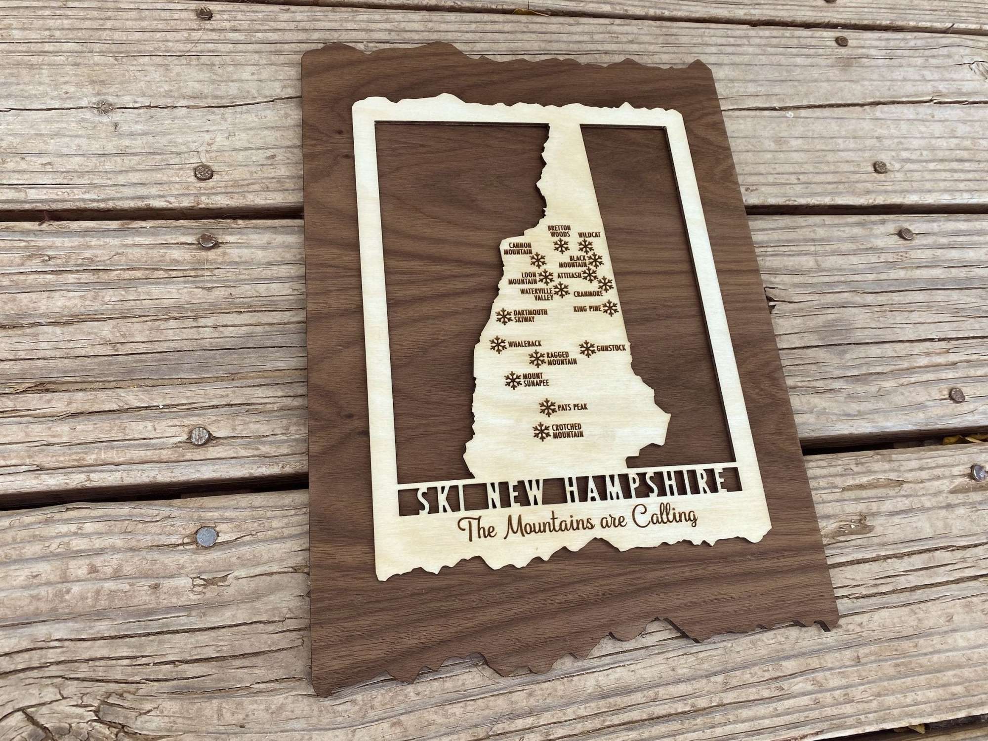 Angled view of Ski New Hampshire Map - Wood Ski Decor - Mountaincut showing engraved ski areas on a natural wood background, ideal for lodge wall art.