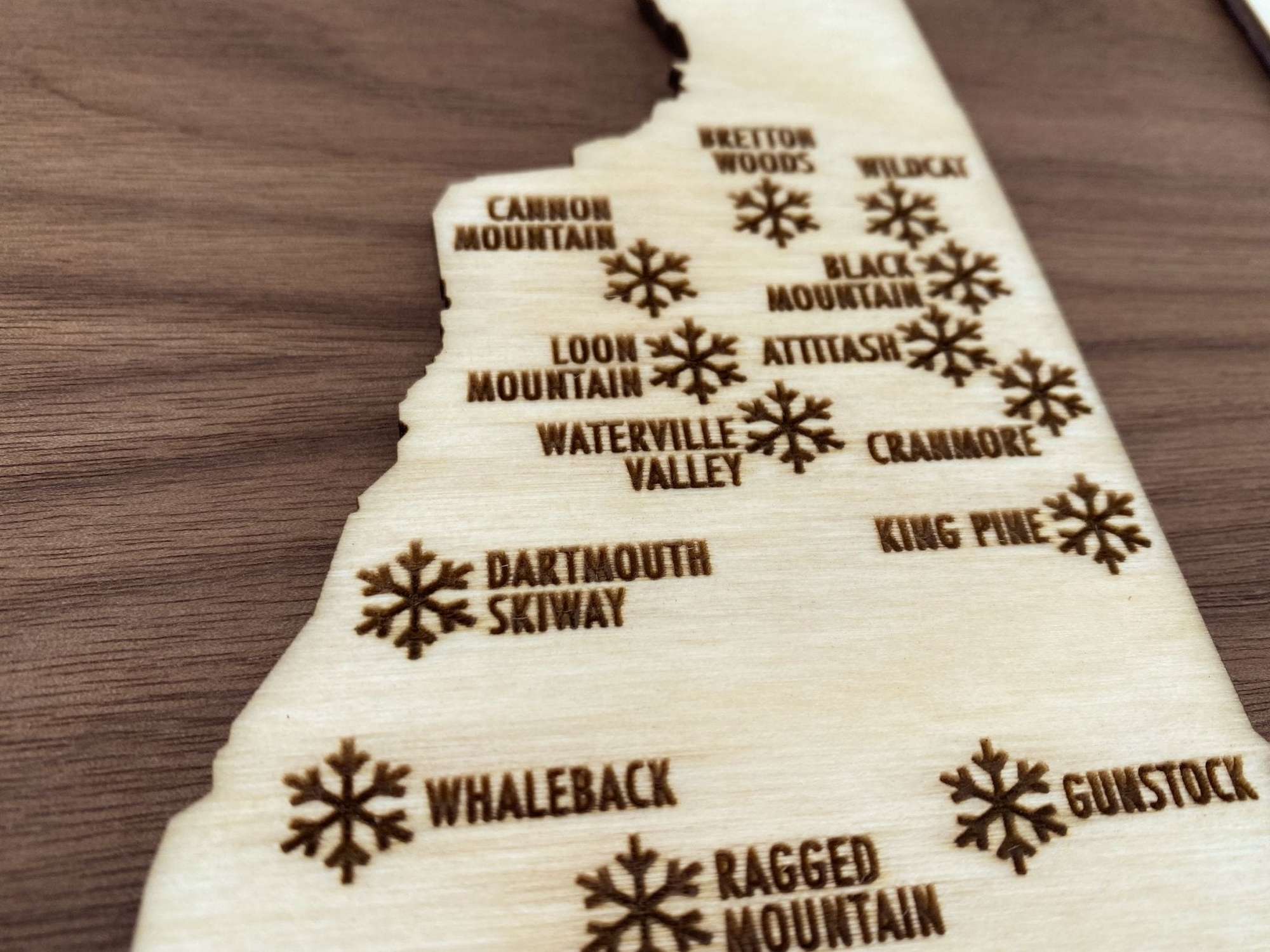 Detailed engraving of northern ski resorts on Ski New Hampshire Map - Wood Ski Decor - Mountaincut, featuring Cannon, Loon, and Waterville Valley.