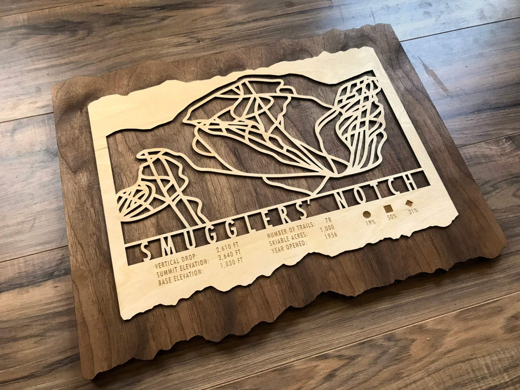 Angled view of Smugglers Notch Ski Trail Map - Wood Wall Decor showing layered wood design and engraved trail layout, ideal for ski-themed home decor.