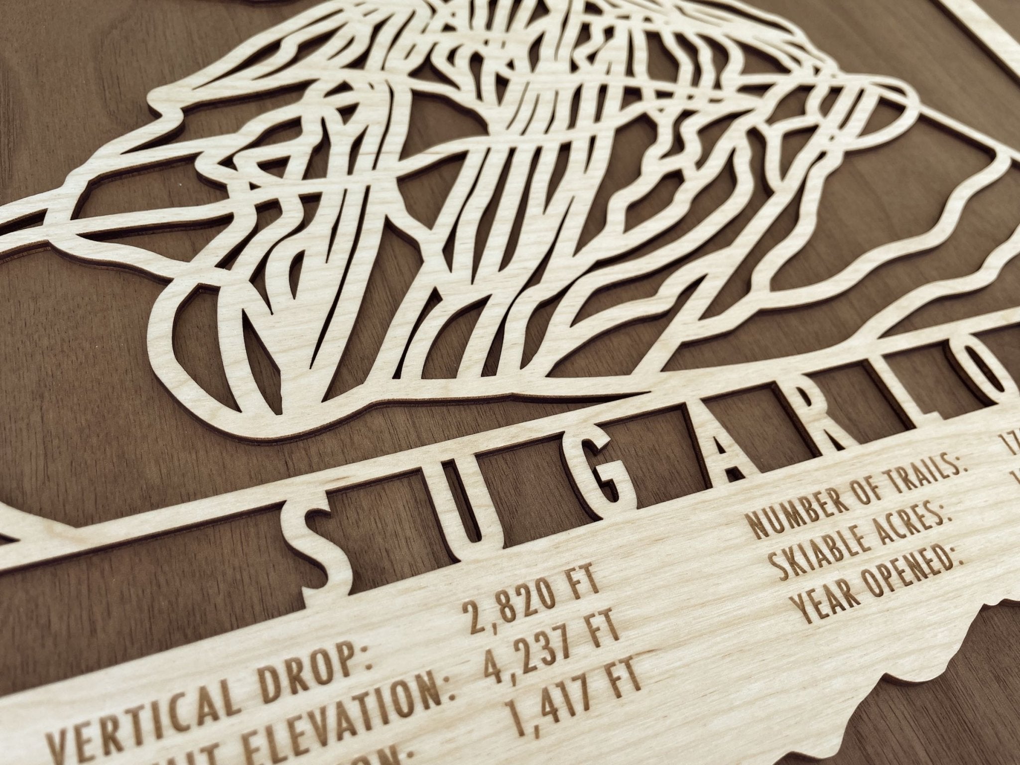 Close-up of Sugarloaf Ski Trail Map - Wood Ski Decor showing intricate laser-cut trail design and engraved resort stats.