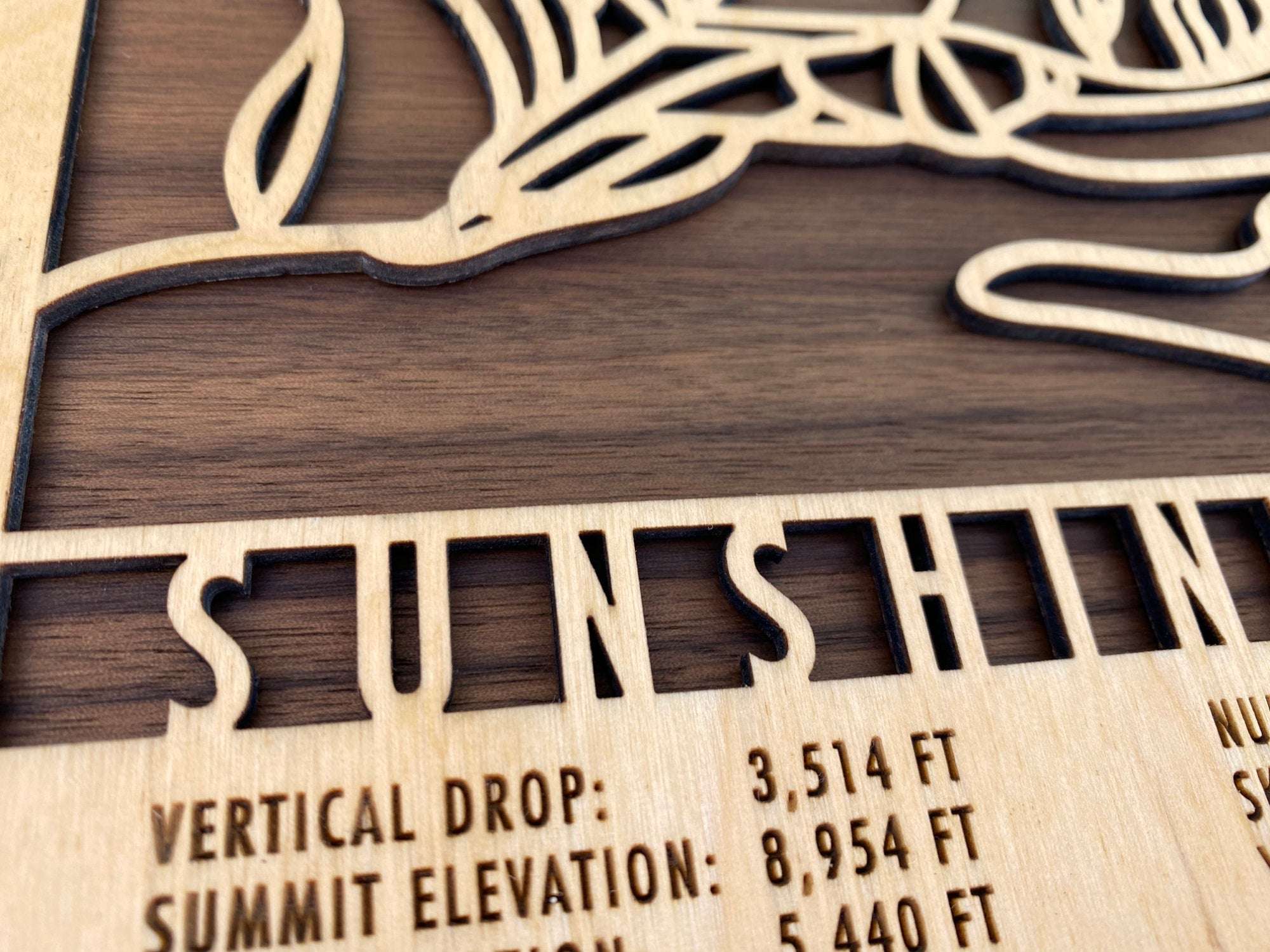 Close-up of Sunshine Village Wood Ski Map highlighting precision laser-cut lettering and elevation details, a premium decor piece for skiers.