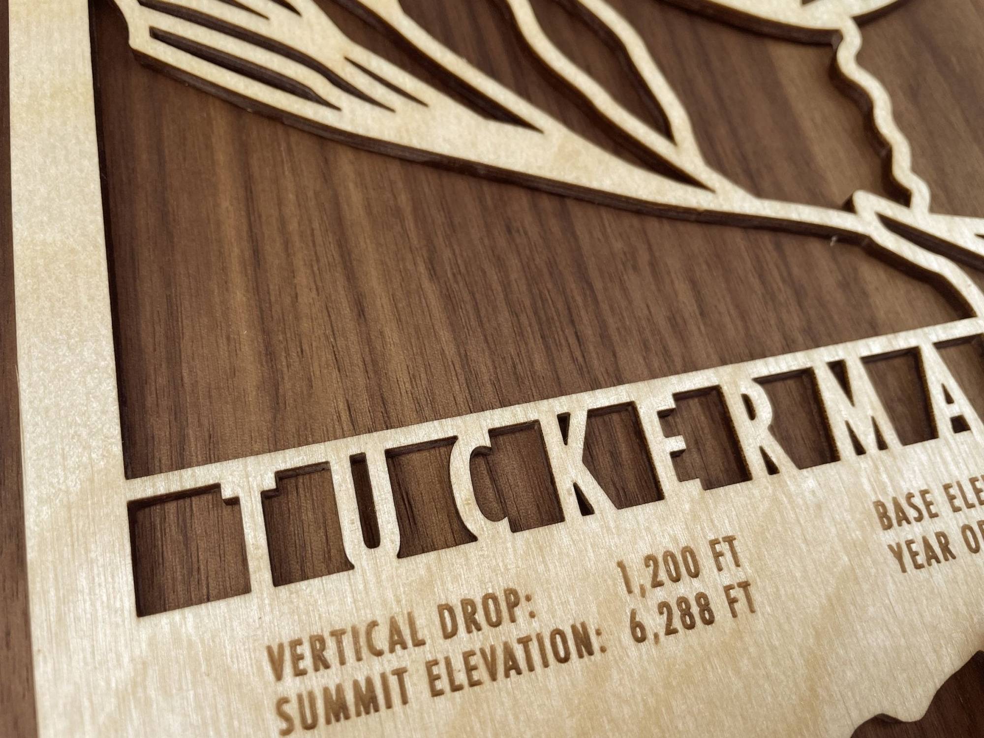 Detailed view of Tuckerman Ravine Map - Wood Ski Decor focusing on engraved summit and vertical drop stats, perfect for ski-themed interiors.