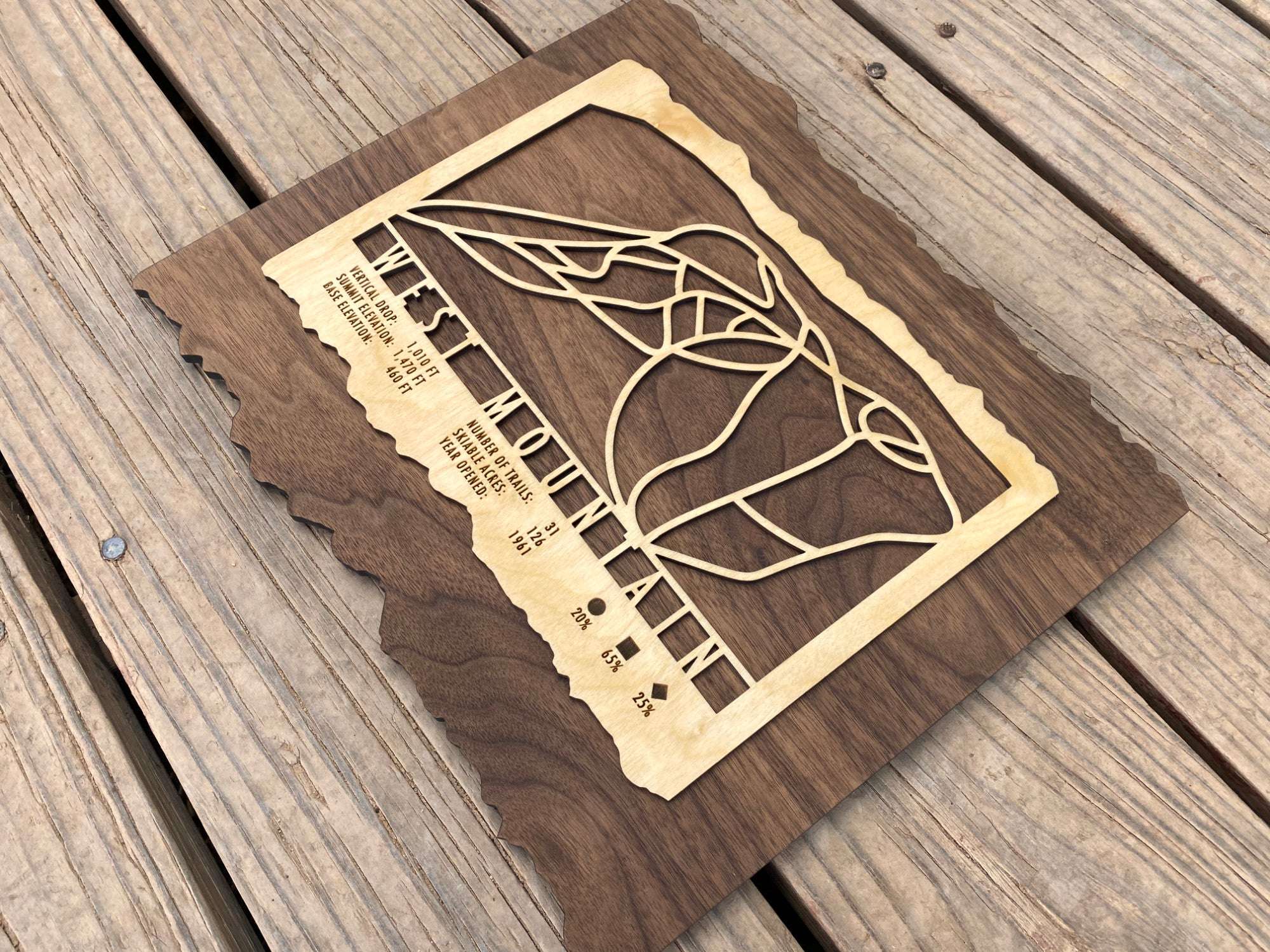Angled view of West Mountain Ski Trail Map - Wood Ski Decor highlighting intricate trail design and engraved ski stats, perfect for home or lodge.